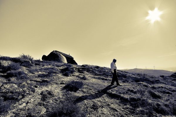 rock house man walking