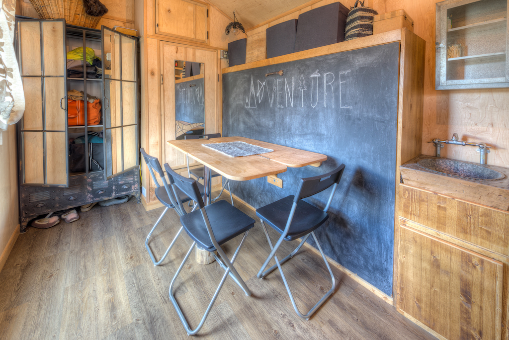 Lewis and Clarks Tiny House in Montana - Bed behind Table